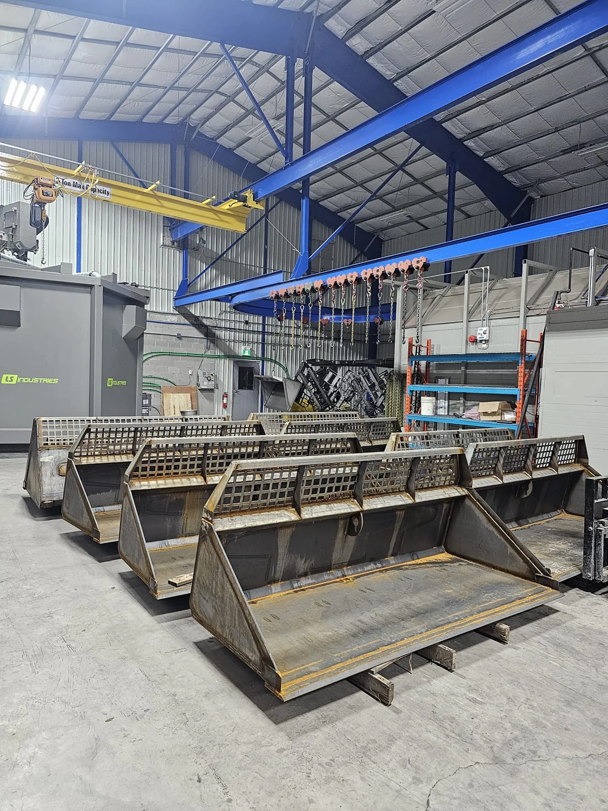 Bare metal equipment buckets staged inside the facility