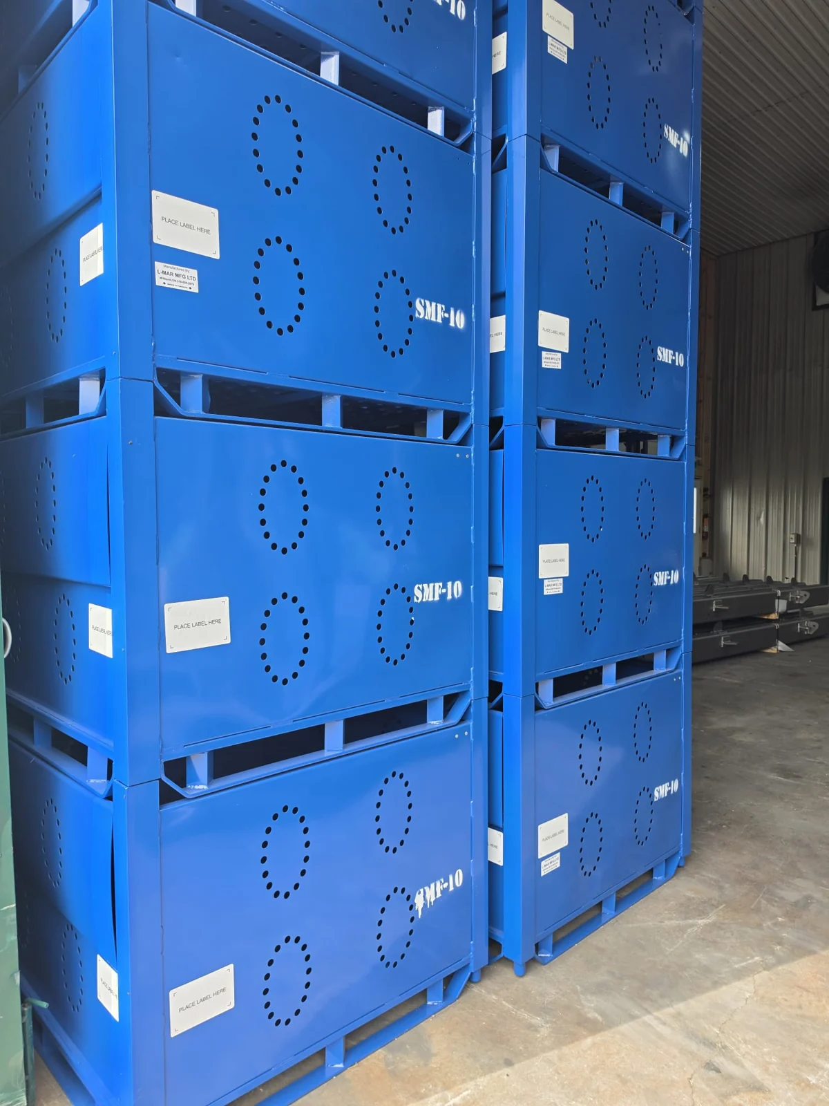 Blue coated industrial enclosures stacked inside the facility