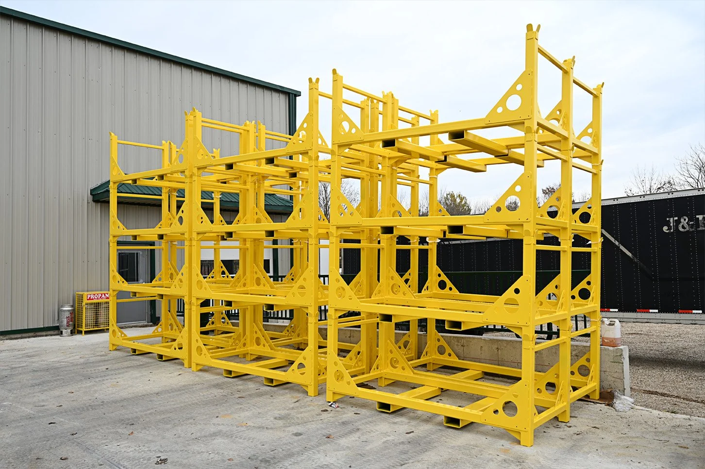 Finished yellow steel racks stacked outside the Mapleside facility