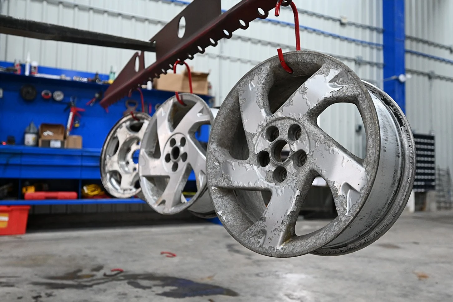 Unfinished wheel rims hanging from the overhead production rail